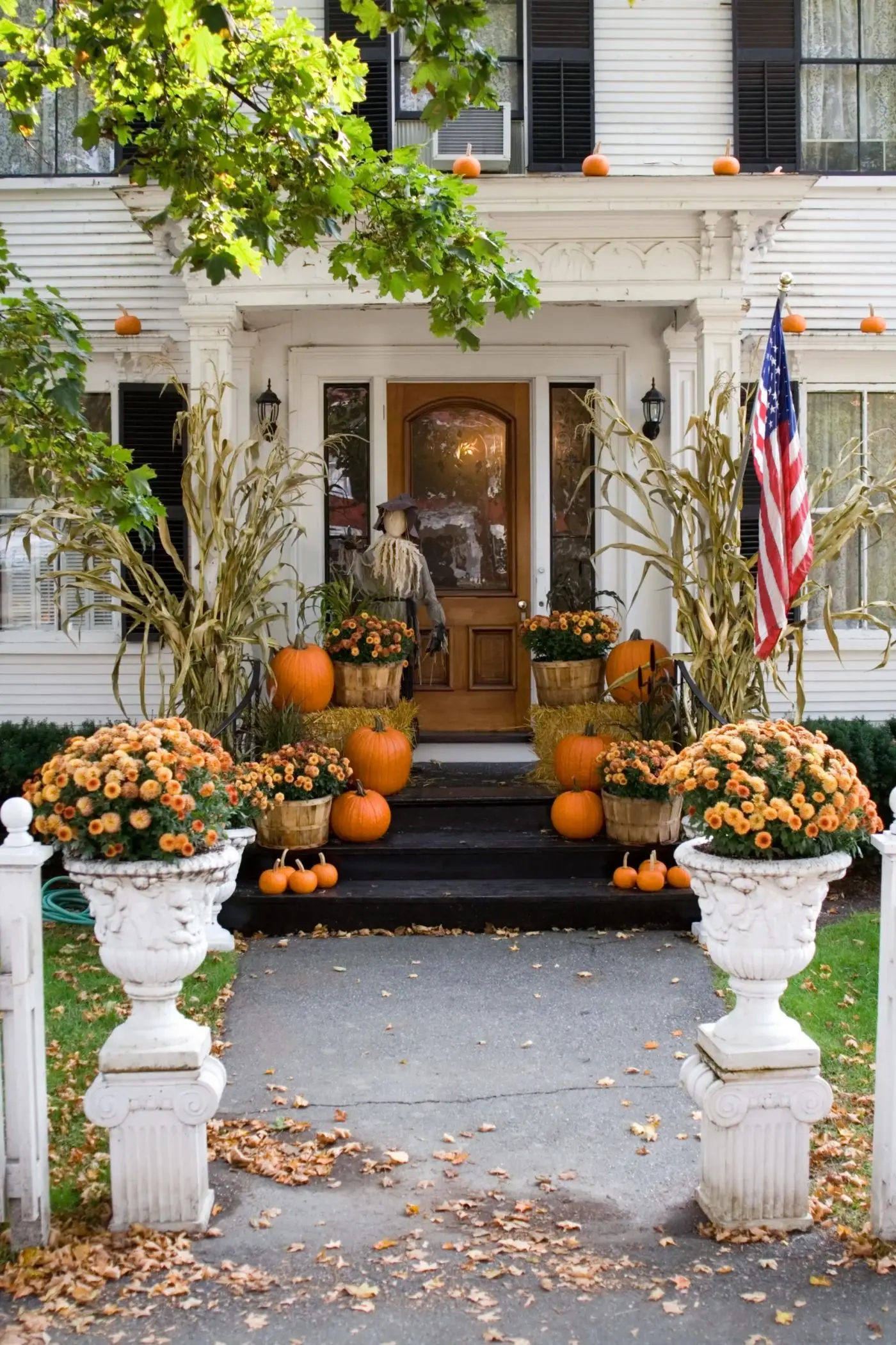 Fall porch installation with layered pumpkins
