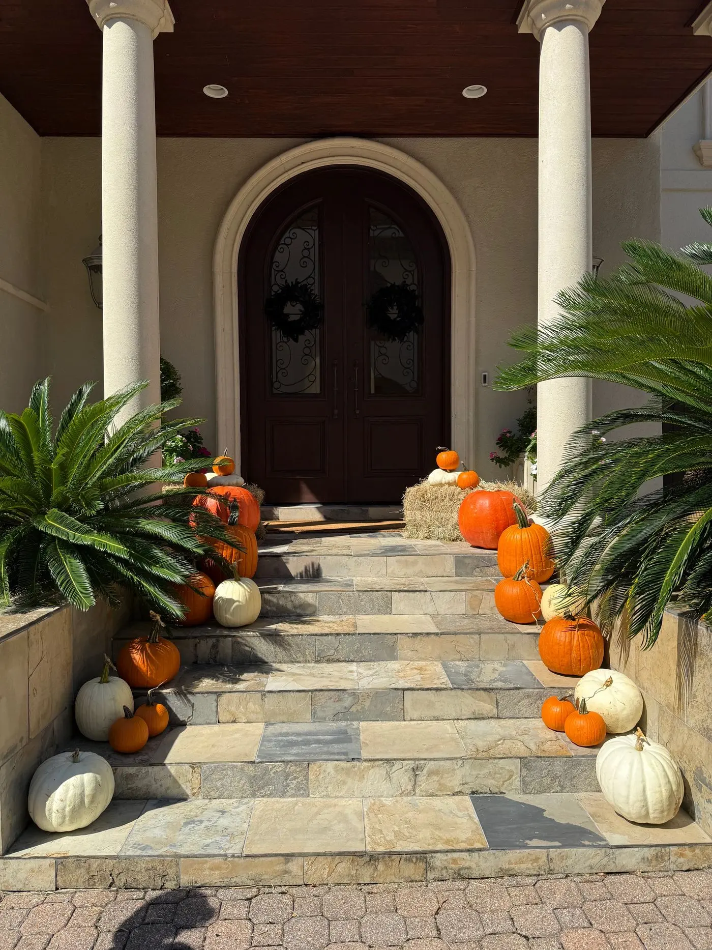 Fall porch installation with layered pumpkins in Tanglewood